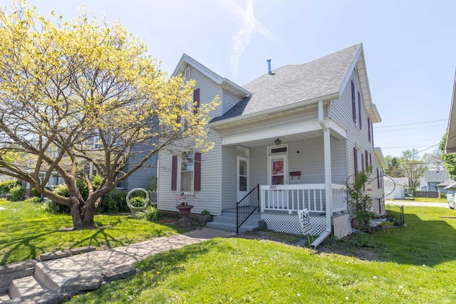 bungalow-style home featuring a porch, roof with shingles, and a front yard