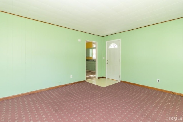 spare room with carpet floors and baseboards