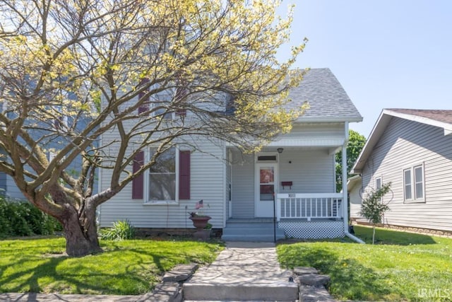 view of front of house featuring covered porch and a front lawn