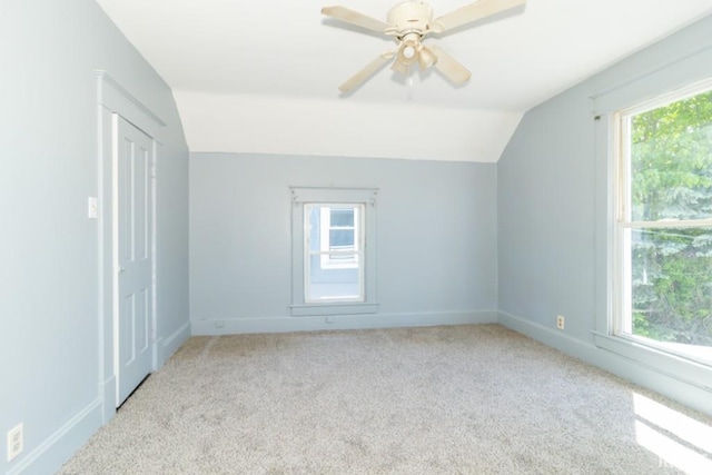additional living space featuring vaulted ceiling, carpet, a ceiling fan, and baseboards