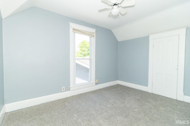 additional living space featuring lofted ceiling, carpet, baseboards, and ceiling fan