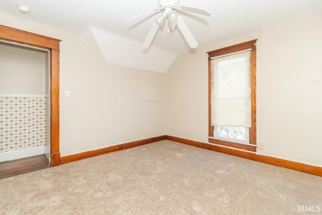 additional living space with baseboards, lofted ceiling, carpet flooring, and ceiling fan