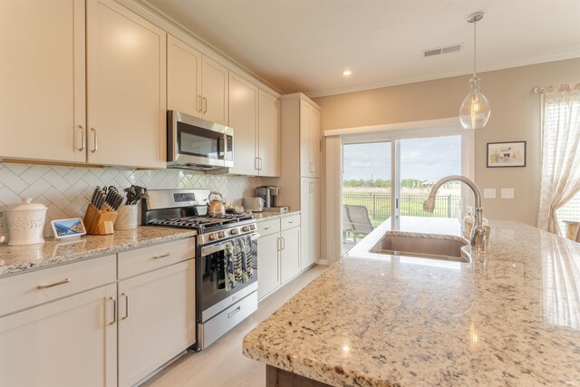 5512 Abbe Wood Dr, Newburgh, IN 47630 - kitchen featuring appliances with stainless steel finishes, a sink, decorative backsplash, ornamental molding, and light stone countertops