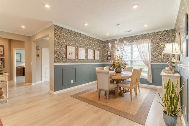 5512 Abbe Wood Dr, Newburgh, IN 47630 - dining space featuring ornamental molding, a chandelier, light wood-style floors, a decorative wall, and a wainscoted wall