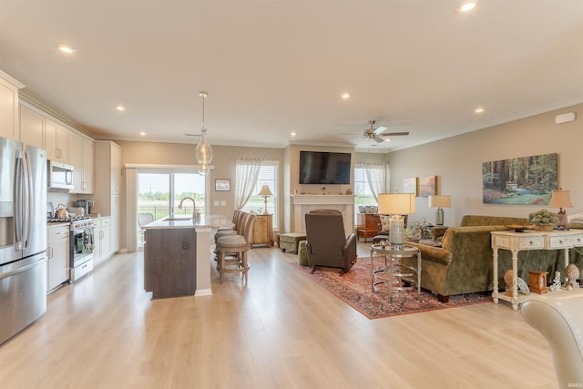 5512 Abbe Wood Dr, Newburgh, IN 47630 - living area with recessed lighting, a ceiling fan, light wood-style flooring, ornamental molding, and a fireplace