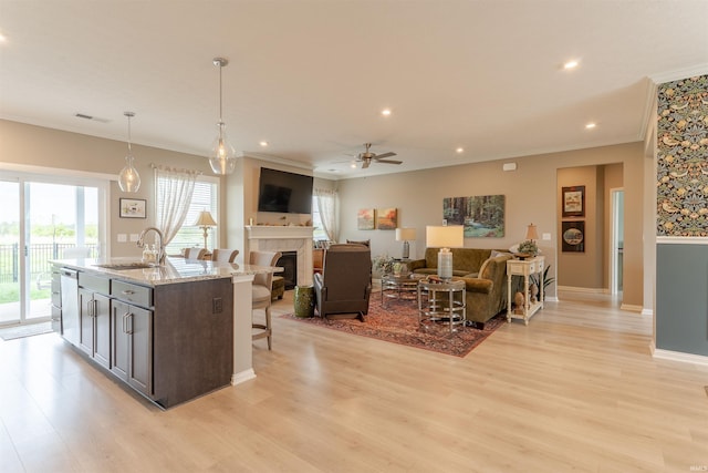 5512 Abbe Wood Dr, Newburgh, IN 47630 - kitchen featuring crown molding, healthy amount of natural light, light wood-style floors, a kitchen breakfast bar, and recessed lighting