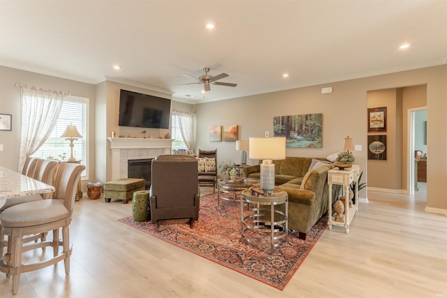5512 Abbe Wood Dr, Newburgh, IN 47630 - living area with light wood-style flooring, a tile fireplace, recessed lighting, a ceiling fan, and crown molding