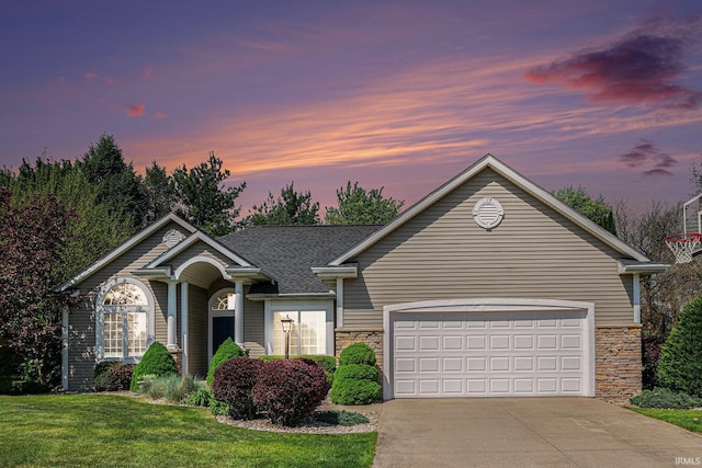 19781 Hidden Meadow Trl, Goshen, IN 46528 - ranch-style home featuring driveway, stone siding, a front lawn, a garage, and a shingled roof