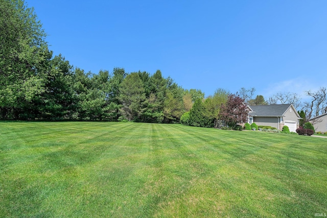 19781 Hidden Meadow Trl, Goshen, IN 46528 - view of green lawn featuring a garage