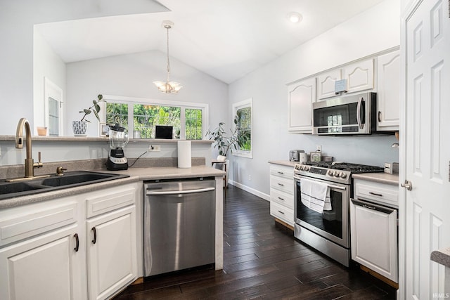 19781 Hidden Meadow Trl, Goshen, IN 46528 - kitchen with stainless steel appliances, a sink, white cabinetry, dark wood-style flooring, and lofted ceiling