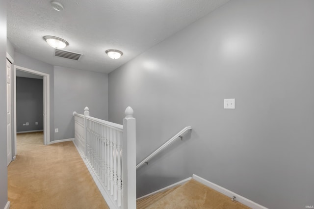 2378 The Springs Dr, Indianapolis, IN 46260 - hallway featuring an upstairs landing, carpet flooring, baseboards, and a textured ceiling