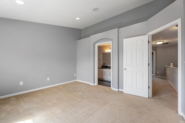 2378 The Springs Dr, Indianapolis, IN 46260 - unfurnished bedroom with light carpet, recessed lighting, baseboards, and connected bathroom