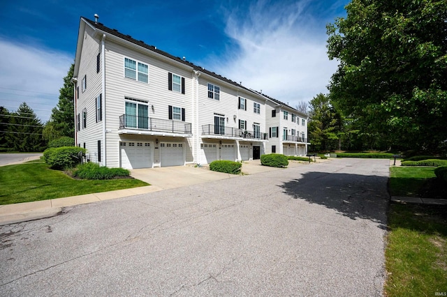 2378 The Springs Dr, Indianapolis, IN 46260 - view of front facade featuring a garage, driveway, and a balcony