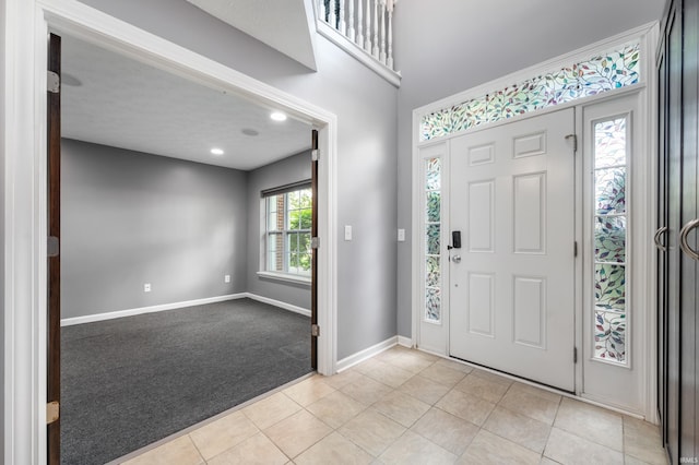 2378 The Springs Dr, Indianapolis, IN 46260 - entryway with light carpet, baseboards, and light tile patterned floors