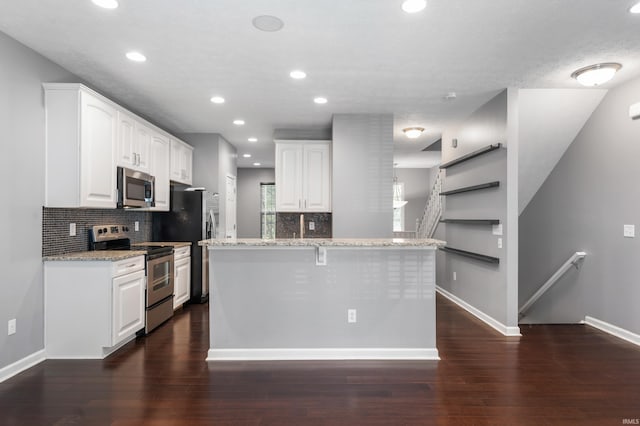 2378 The Springs Dr, Indianapolis, IN 46260 - kitchen with appliances with stainless steel finishes, backsplash, light stone counters, white cabinetry, and baseboards