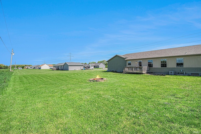 26183 Northland Crossing Dr, Elkhart, IN 46514 - view of grassy yard featuring a fire pit and a wooden deck