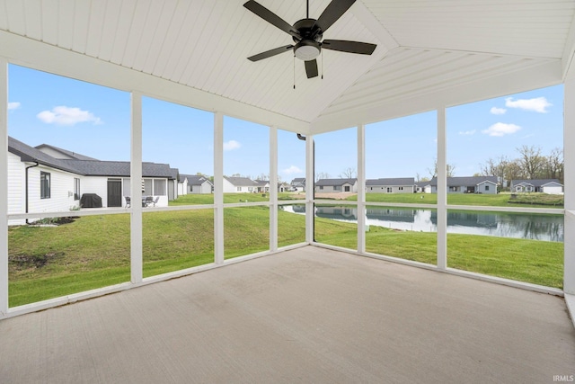 unfurnished sunroom with a water view, a residential view, ceiling fan, lofted ceiling, and plenty of natural light
