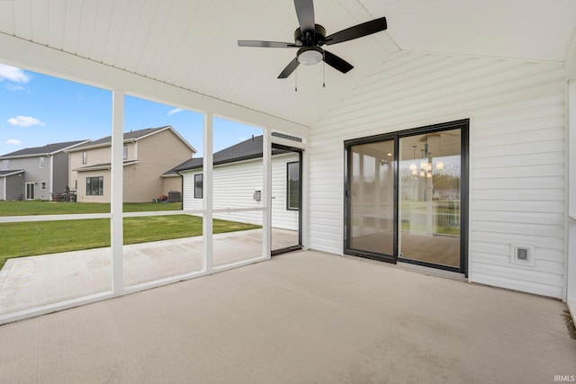 unfurnished sunroom featuring a ceiling fan and vaulted ceiling