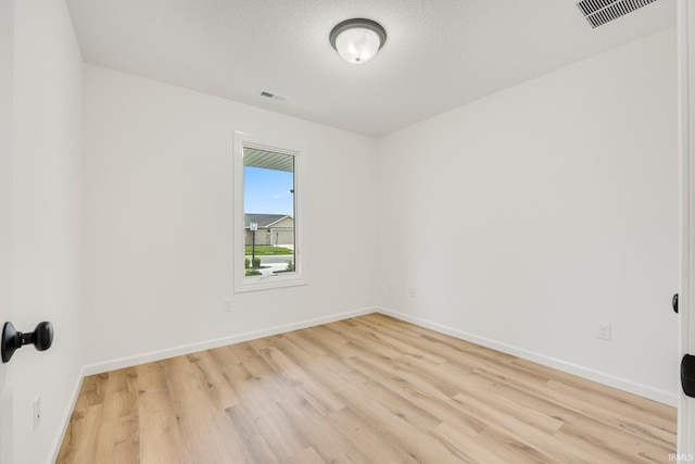 empty room with light wood-style flooring and baseboards