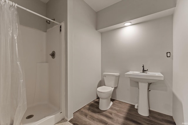 25860 Running Creek Dr, South Bend, IN 46628 - full bath with a stall shower, toilet, wood finished floors, and baseboards