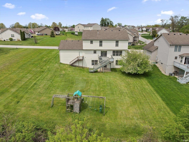 25860 Running Creek Dr, South Bend, IN 46628 - back of house featuring a residential view, stairs, a yard, and a deck