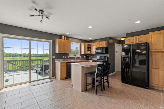 25860 Running Creek Dr, South Bend, IN 46628 - kitchen featuring black appliances, glass insert cabinets, a kitchen island, recessed lighting, and light tile patterned floors