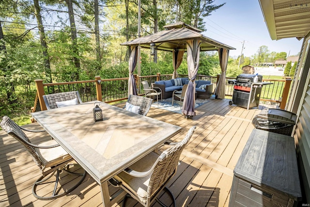 wooden terrace featuring an outdoor hangout area, area for grilling, outdoor dining area, and a gazebo