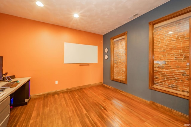 28 N Washington St, Knightstown, IN 47362 - empty room with wood finished floors, recessed lighting, baseboards, and an office area