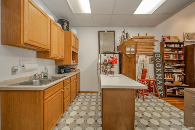 28 N Washington St, Knightstown, IN 47362 - kitchen with light flooring, a sink, light countertops, and a paneled ceiling
