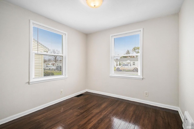 1803 W Dubail St, South Bend, IN 46613 - empty room featuring healthy amount of natural light, baseboards, and dark wood-type flooring