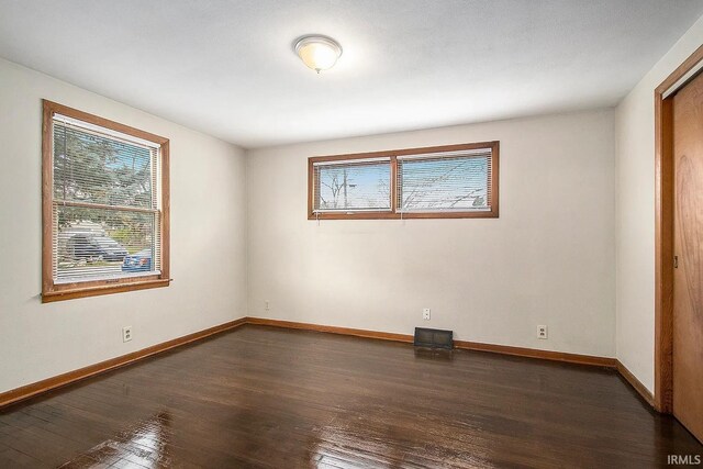 1803 W Dubail St, South Bend, IN 46613 - empty room featuring healthy amount of natural light, wood-type flooring, and baseboards