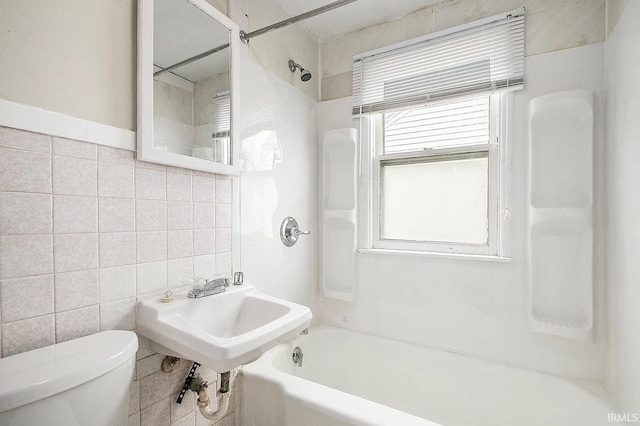 1803 W Dubail St, South Bend, IN 46613 - bathroom featuring toilet, tile walls, and bathing tub / shower combination