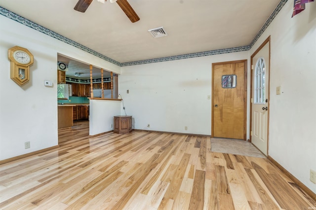 2105 N 100 W, Winchester, IN 47394 - unfurnished living room with light wood-style floors, ceiling fan, and baseboards