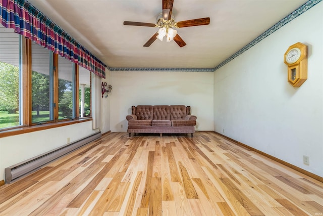 2105 N 100 W, Winchester, IN 47394 - sitting room featuring a baseboard heating unit, a ceiling fan, and wood finished floors