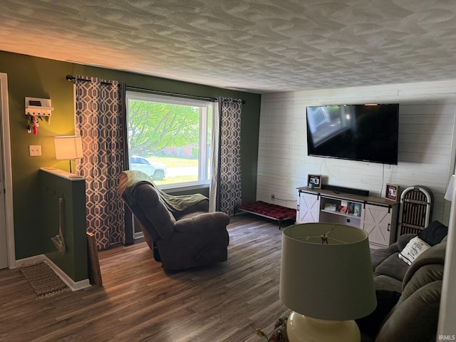 310 Edgeway Dr, Alexandria, IN 46001 - living area with dark wood-type flooring, wooden walls, a textured ceiling, and baseboards