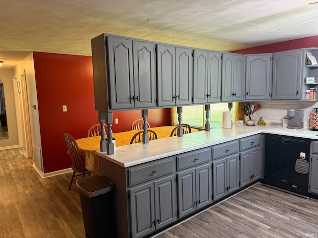 310 Edgeway Dr, Alexandria, IN 46001 - kitchen featuring gray cabinetry, dishwasher, wood finished floors, and light countertops
