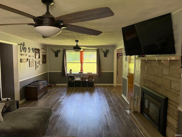 310 Edgeway Dr, Alexandria, IN 46001 - living room with ceiling fan, dark wood-style flooring, a stone fireplace, and baseboards