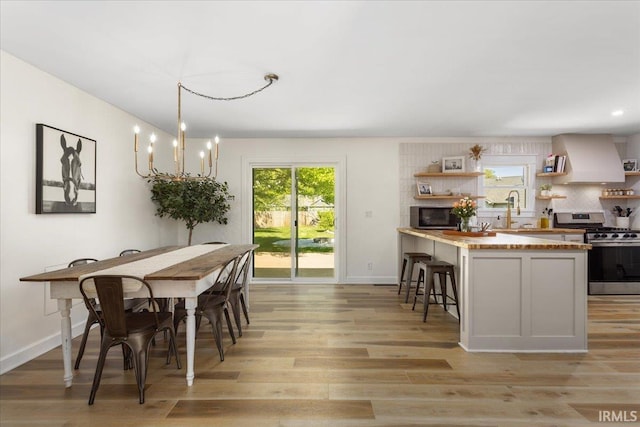 736 Paradise Ave, Lafayette, IN 47905 - dining area with light wood-style flooring, baseboards, and a chandelier