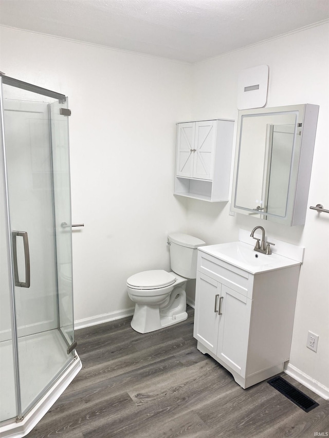 710 N Union St, Union City, IN 47390 - bathroom featuring baseboards, a stall shower, wood finished floors, toilet, and vanity