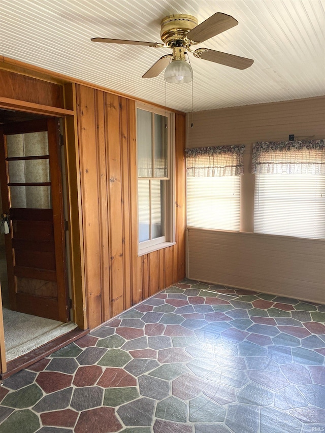 710 N Union St, Union City, IN 47390 - empty room with stone flooring, wood walls, and a ceiling fan