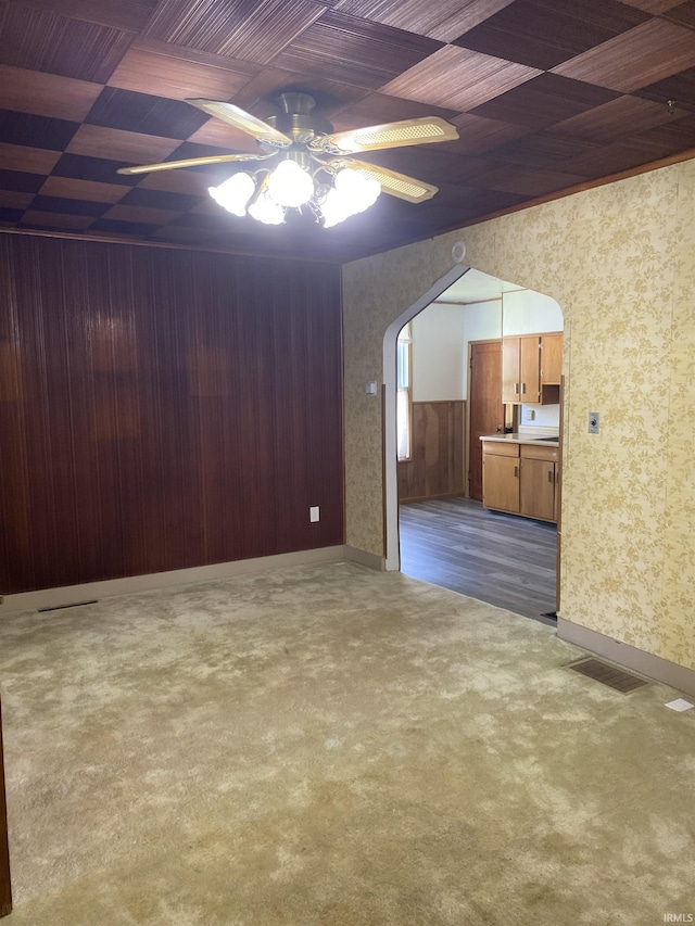 710 N Union St, Union City, IN 47390 - unfurnished living room with wallpapered walls, ceiling fan, carpet floors, arched walkways, and baseboards