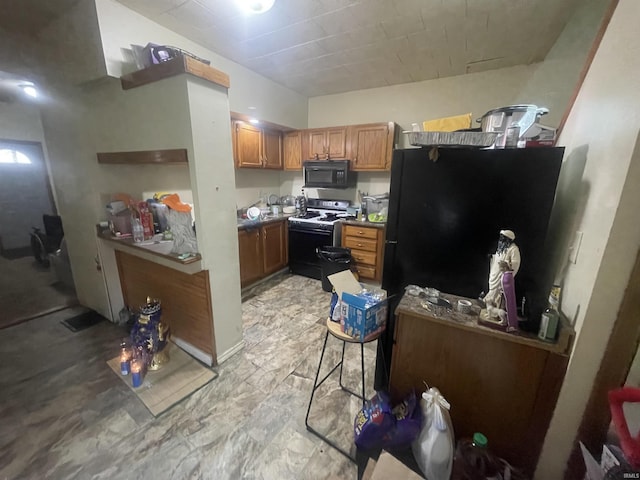 215 Wheatland Avenue St, Logansport, IN 46947 - kitchen with black appliances and brown cabinets