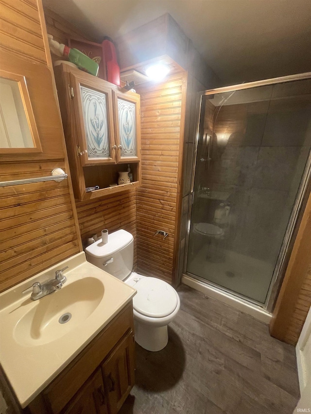 215 Wheatland Avenue St, Logansport, IN 46947 - bathroom with a shower stall, toilet, wood finished floors, vanity, and wood walls