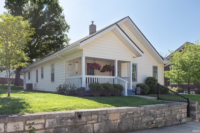 559 S Lincoln St, Bloomington, IN 47401 - view of front of home featuring a chimney, central AC, a porch, and a front lawn