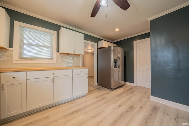 323 N Berkley Rd, Kokomo, IN 46901 - kitchen featuring stainless steel fridge, wood counters, decorative backsplash, white cabinetry, and crown molding