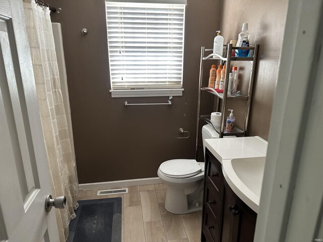 4909 Leicester Way, West Lafayette, IN 47906 - full bathroom with toilet, vanity, a shower with shower curtain, and baseboards