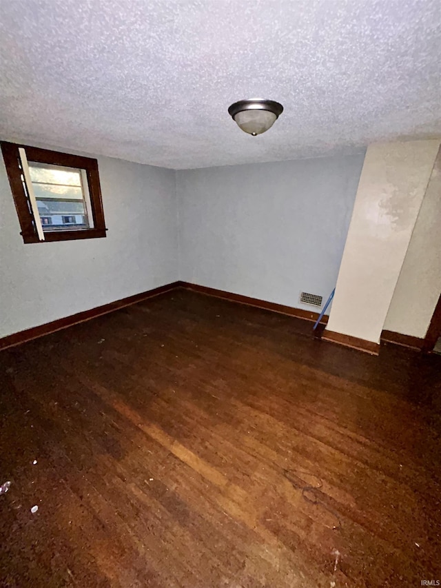 312 Horace Mann Ct, Marion, IN 46952 - unfurnished room with wood finished floors, a textured ceiling, and baseboards