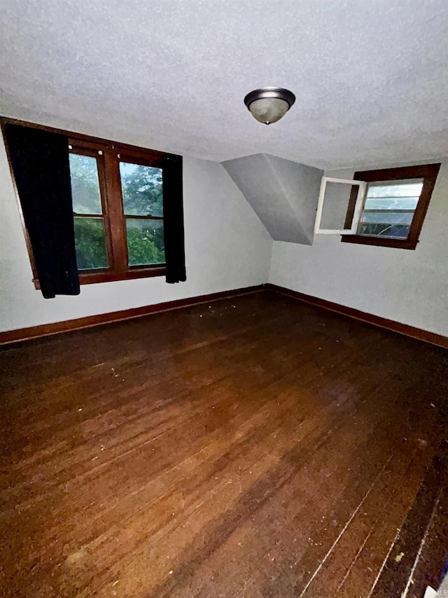 312 Horace Mann Ct, Marion, IN 46952 - additional living space with a textured ceiling, hardwood / wood-style flooring, baseboards, and vaulted ceiling