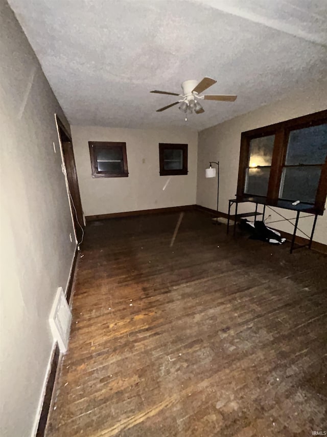 312 Horace Mann Ct, Marion, IN 46952 - unfurnished living room featuring wood finished floors, ceiling fan, baseboards, and a textured ceiling