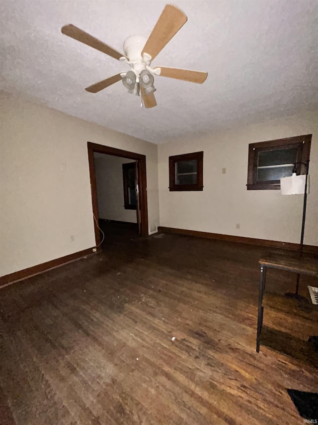 312 Horace Mann Ct, Marion, IN 46952 - unfurnished living room featuring wood finished floors, baseboards, a textured ceiling, and a ceiling fan